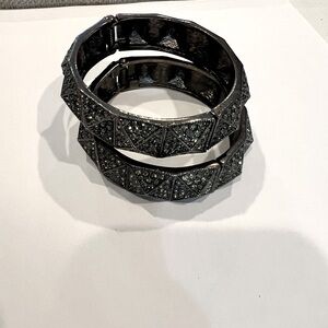 BCBG Blue Crystal bangles on black metal